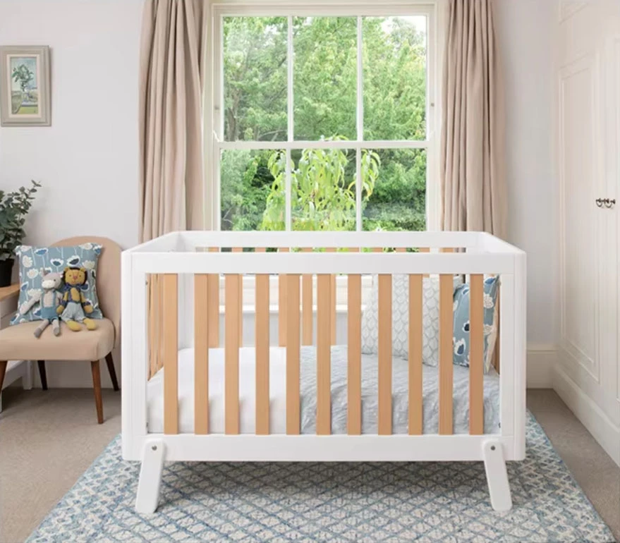White wooden cot bed with natural timber slats in a nursery, the model covered by the Intertek EN 716 test report White wooden cot bed with natural timber slats in a nursery, the model covered by the Intertek EN 716 test report